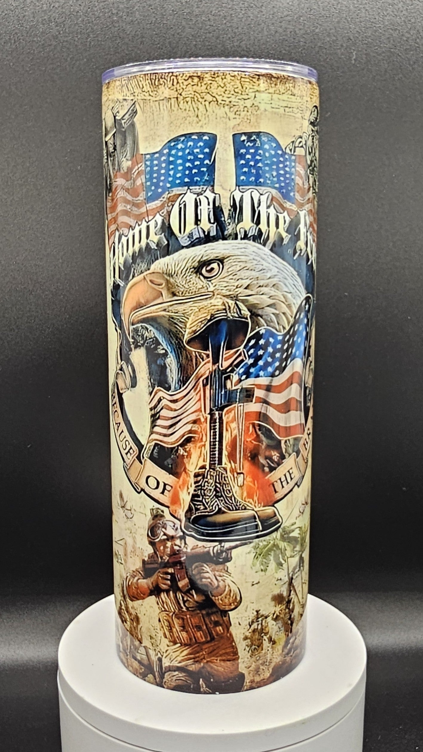 Tumbler with American flag, eagle, and soldier design on a dark background